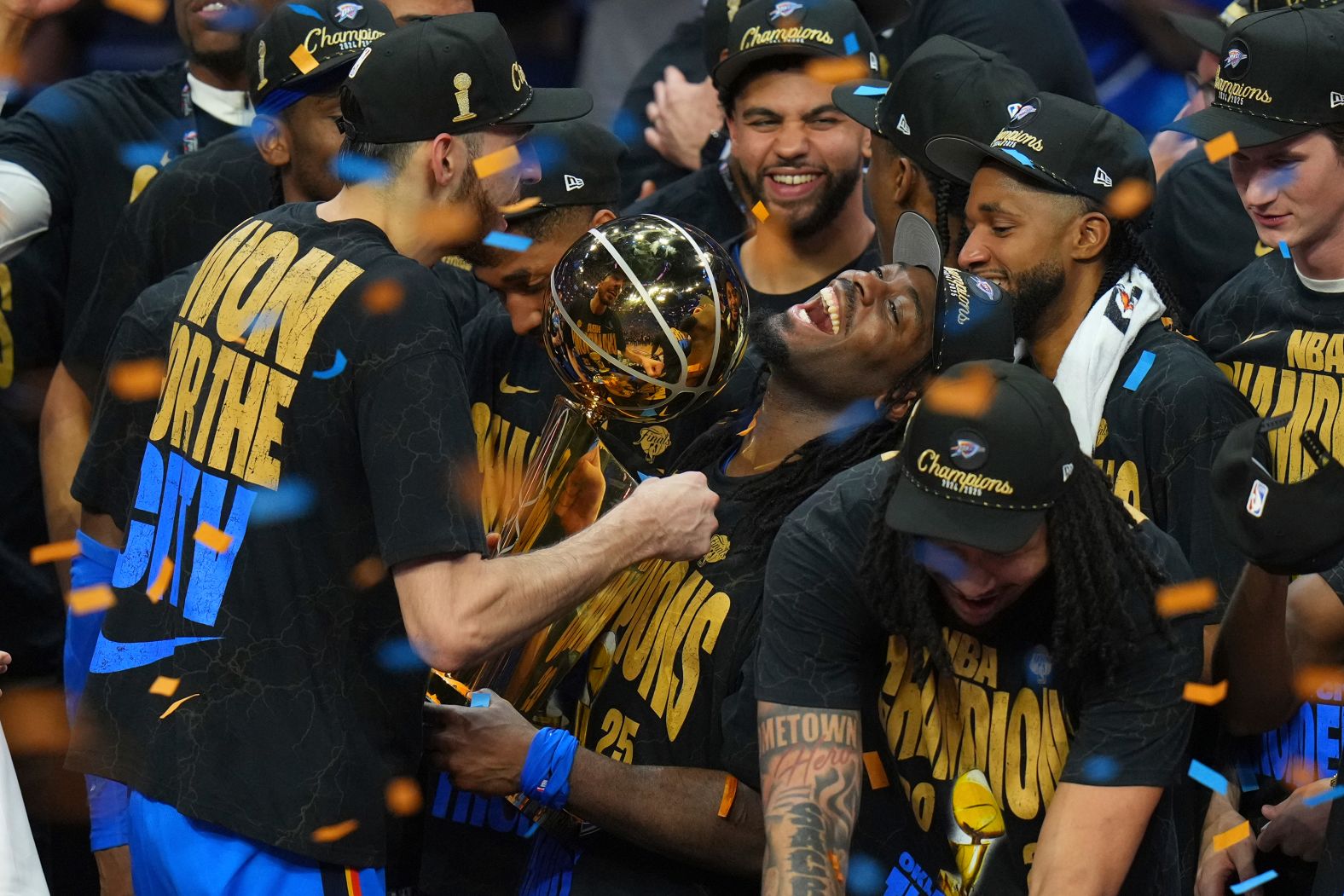 Luguentz Dort holds the Larry O'Brien Championship Trophy as the Oklahoma City Thunder <a href="index.php?page=&url=https%3A%2F%2Fwww.cnn.com%2F2025%2F06%2F23%2Fsport%2Foklahoma-city-thunder-nba-title-spt-intl">celebrate their NBA title</a> on Sunday, June 22. The Thunder defeated the Indiana Pacers in Game 7 of the Finals to cap off one of the winningest seasons in league history.