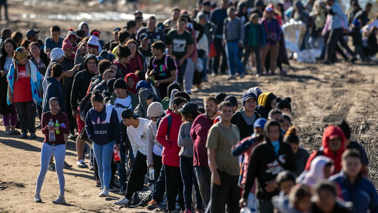 Hundreds of migrants wait in line to be processed by US Border Patrol agents in Eagle Pass, Texas, in December.