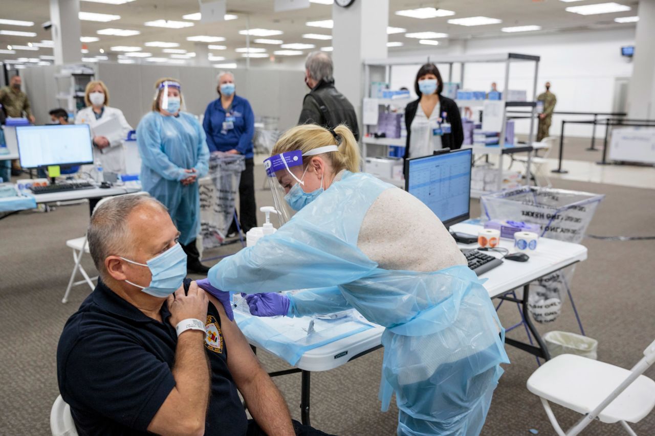 Sergeant Brian Patrick McKnerney, of the New Jersey State Police, receives a COVID-19 vaccination at the Morris County vaccination site, in Rockaway, New Jersey, on January 8.