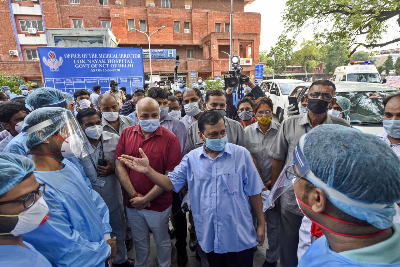 Delhi Chief Minister Arvind Kejriwal, center, gestures as he speaks to medical professionals at Lok Nayak Jai Prakash Narayan Hospital in New Delhi, India, on Thursday, June 25.