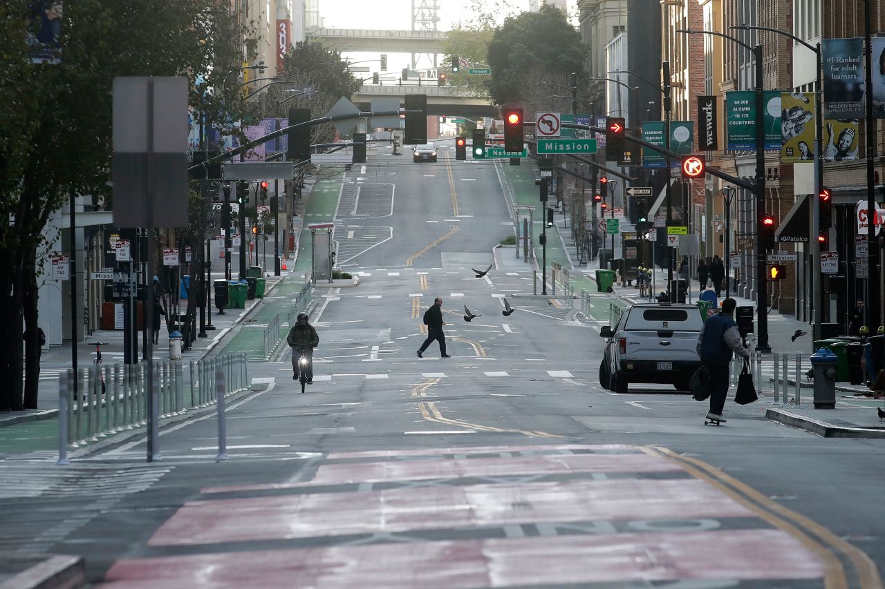 A man crosses a nearly empty street in San Francisco, on Tuesday.