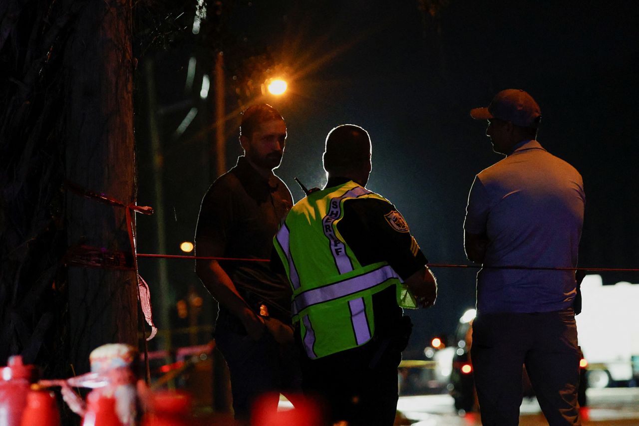 Law enforcement personnel investigate the area around Trump International Golf Club after an apparent assassination attempt of former President Donald Trump on September 15.