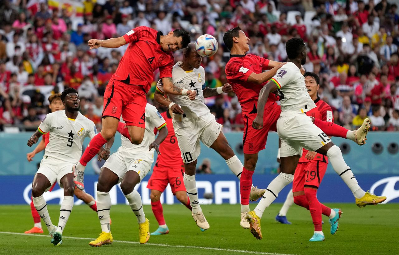 South Korea's Kim Min-jae, left, and Ghana's Andre Ayew, right, jump to head the ball on Monday.