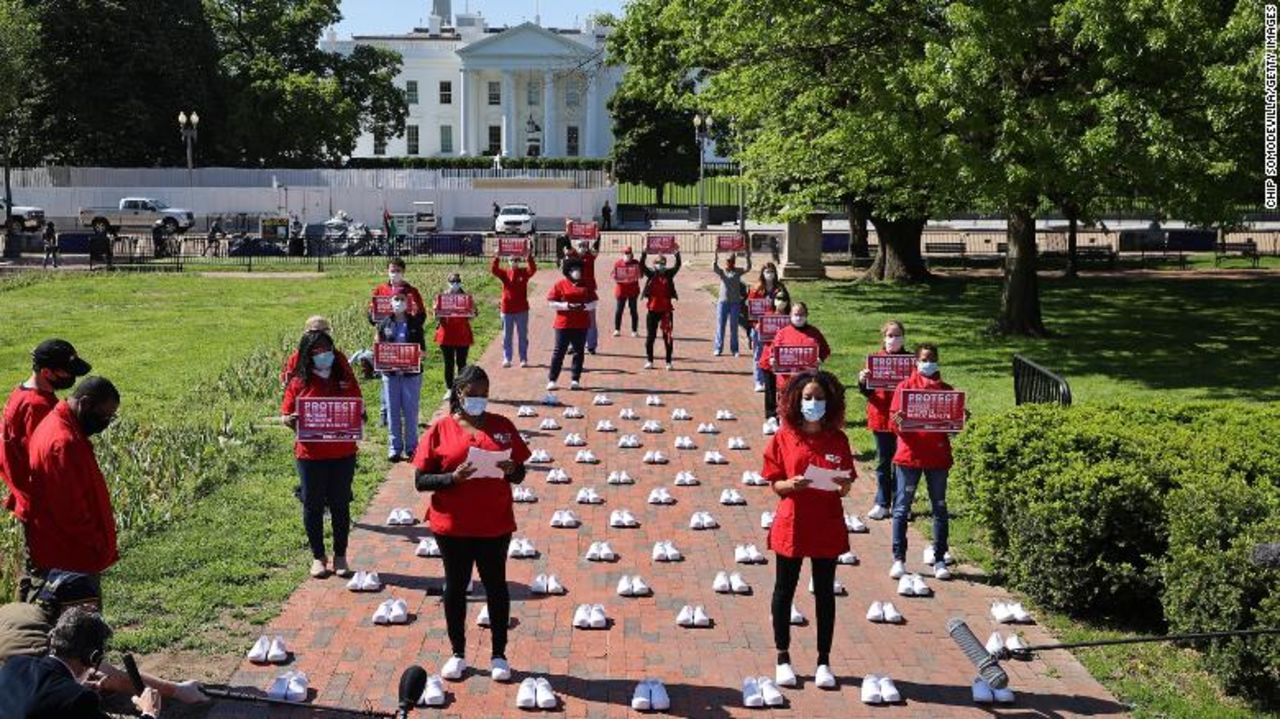 Members of National Nurses United demonstrate in Lafayette Park, across from the White House in Washington, on May 7. They are standing among 88 pairs of empty shoes representing nurses whom they say have died from Covid-19.