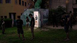 Israeli soldiers and residents gather near a public bomb shelter after receiving a message alerting about an incoming missile launched from Iran, in Holon, central Israel, on Tuesday, June 24, 2025. (AP Photo/Bernat Armangue)