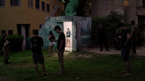 Israeli soldiers and residents gather near a public bomb shelter after receiving a message alerting about an incoming missile launched from Iran, in Holon, central Israel, on Tuesday, June 24, 2025. (AP Photo/Bernat Armangue)