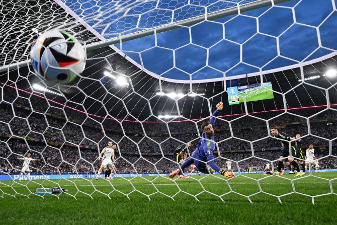 Germany's Jamal Musiala, in white on the right, scores a goal against Scotland during the opening match of Euro 2024 on Friday, June 14. Germany, the host nation, <a href=