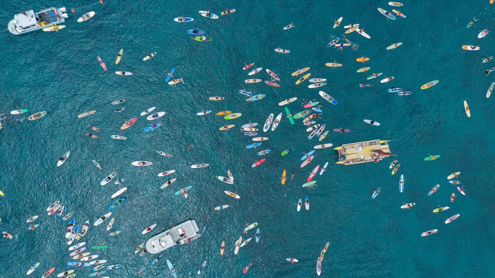 Surfers participate in a paddle-out ceremony on <a >the one-year anniversary of the Lahaina wildfire</a> in Hawaii on Thursday, August 8. The wildfire, fueled by winds from Hurricane Dora, ripped through the town on Maui’s west coast.