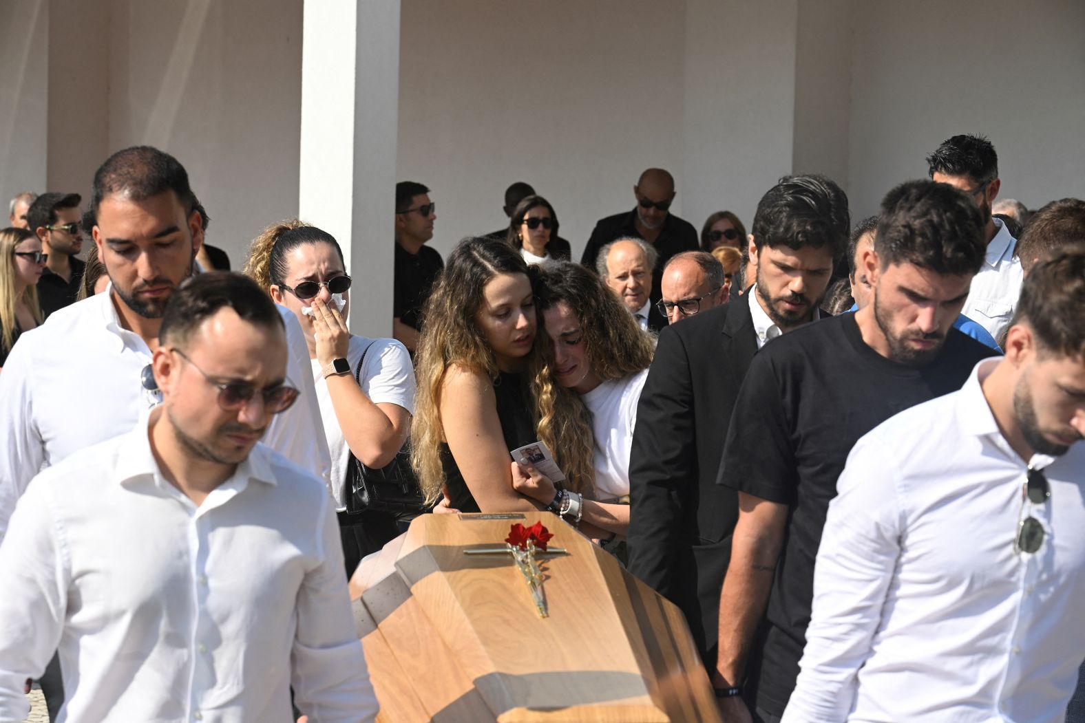 Rute Cardoso, center right, reacts at the funeral of her husband, <a href="index.php?page=&url=https%3A%2F%2Fwww.cnn.com%2F2025%2F07%2F04%2Fsport%2Fgallery%2Fremembering-diogo-jota">soccer star Diogo Jota</a>, in Gondomar, Portugal, on Saturday, July 5. Jota, 28, and his 25-year-old brother, André Silva, died in a car crash in Spain on July 3.