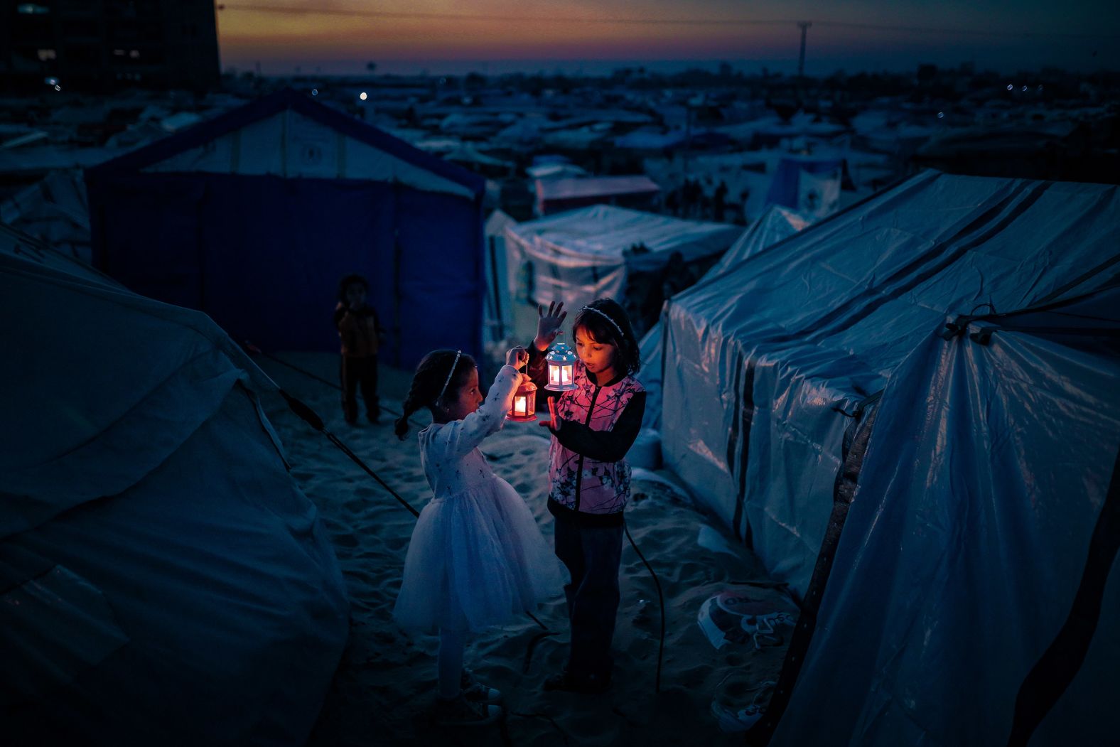 Palestinian refugees in Rafah, Gaza, decorate their tents with lanterns on February 29 ahead of the Muslim holy month of Ramadan. The United Nations estimates that nearly 2 million people in Gaza — or 9 in 10 people — have been displaced again, at least once, since October 7, 2023.