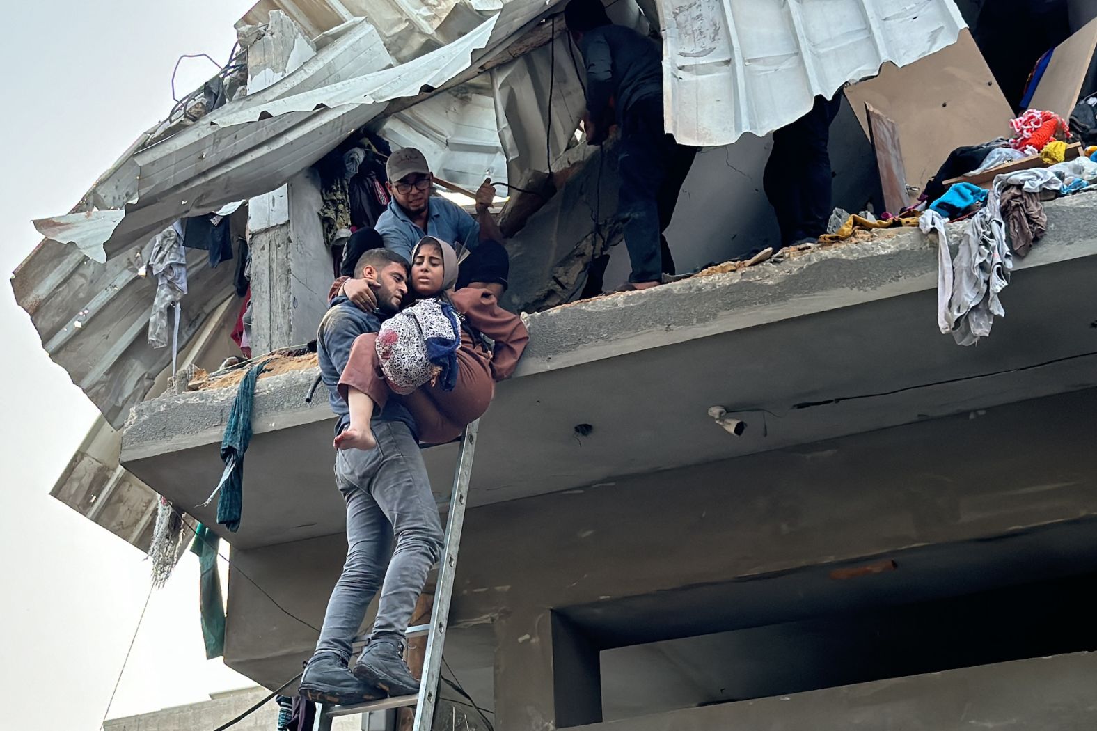 A Palestinian woman, who lost her leg when her family home was hit in an Israeli strike in the Jabalya refugee camp in Gaza, is carried down a ladder on Thursday, November 7.