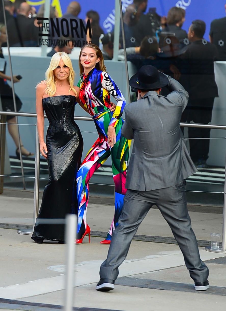 Versace poses for a photo with model Gigi Hadid in New York in 2018.