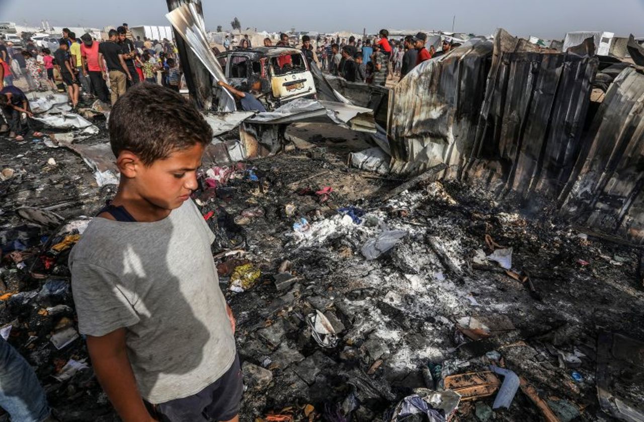 Palestinians inspect destroyed tents after an Israeli air strike in the Al-Mawasi area in Rafah, Gaza, on May 27.