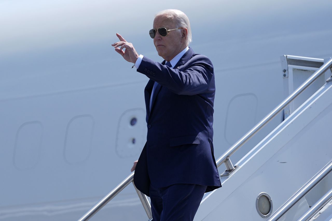 U.S. President Joe Biden gestures as he arrives at Carpiquet airport in Caen, France, today.