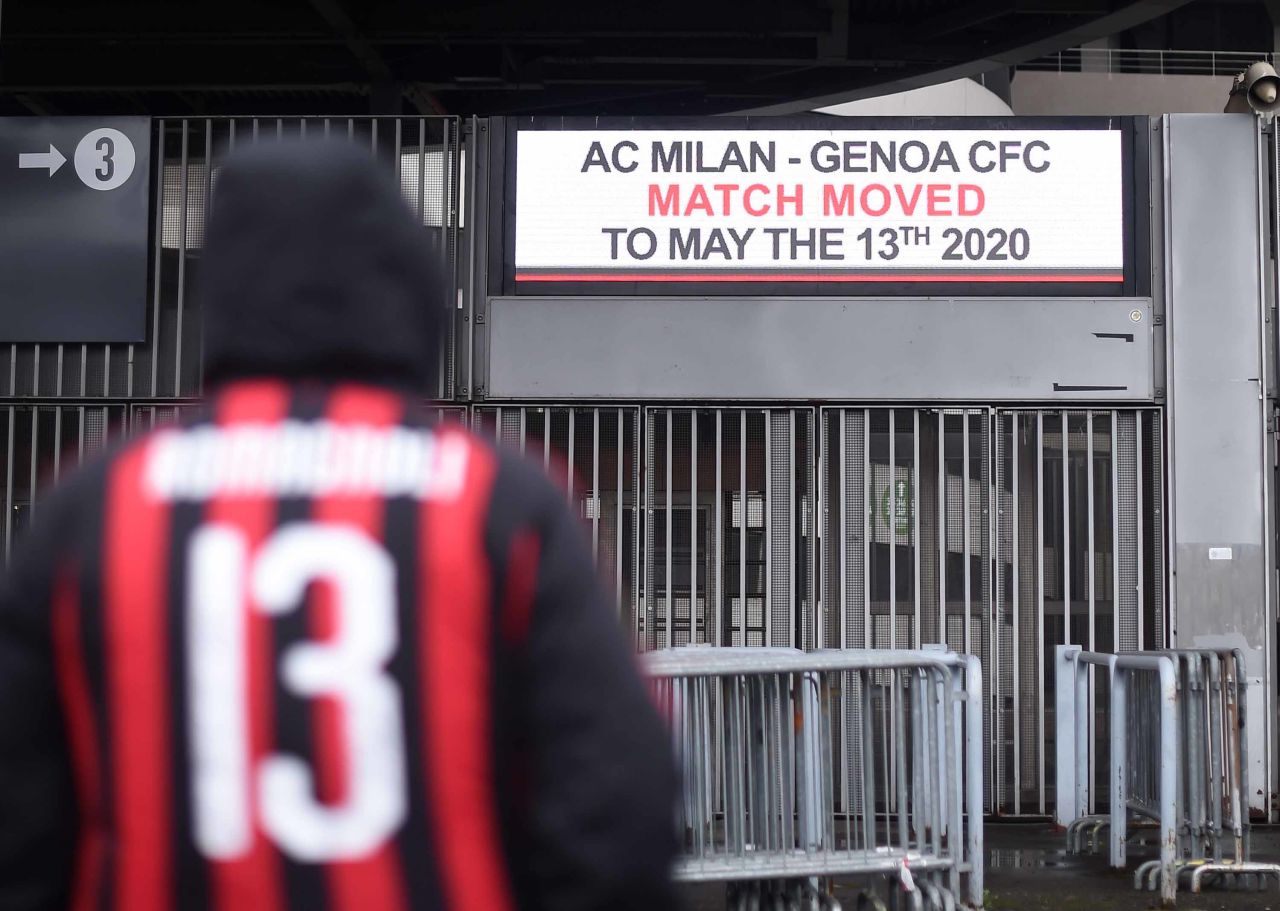 A fan stands outside the San Siro stadium in Milan, Italy on March 1, after a Serie A soccer match between AC Milan and Genoa was postponed due to the recent coronavirus outbreak.