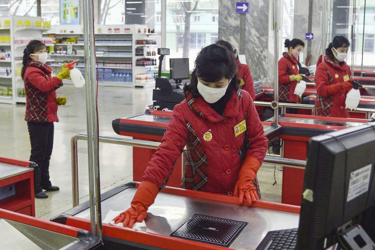 A woman disinfects a department store in Pyongyang on February 28, 2020, to prevent coronavirus infections. 