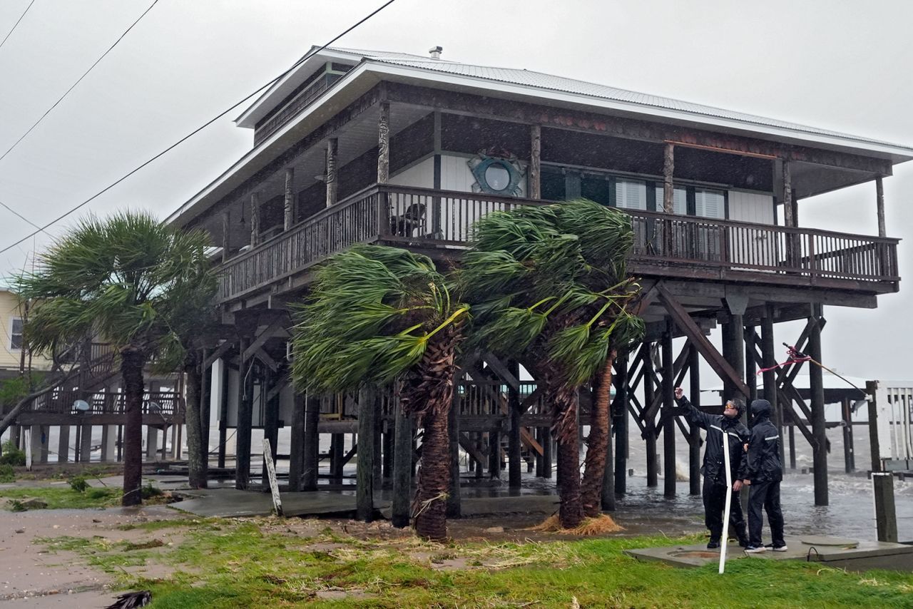 Storm chasers check the wind speed on Monday in Horseshoe Beach, Florida. 