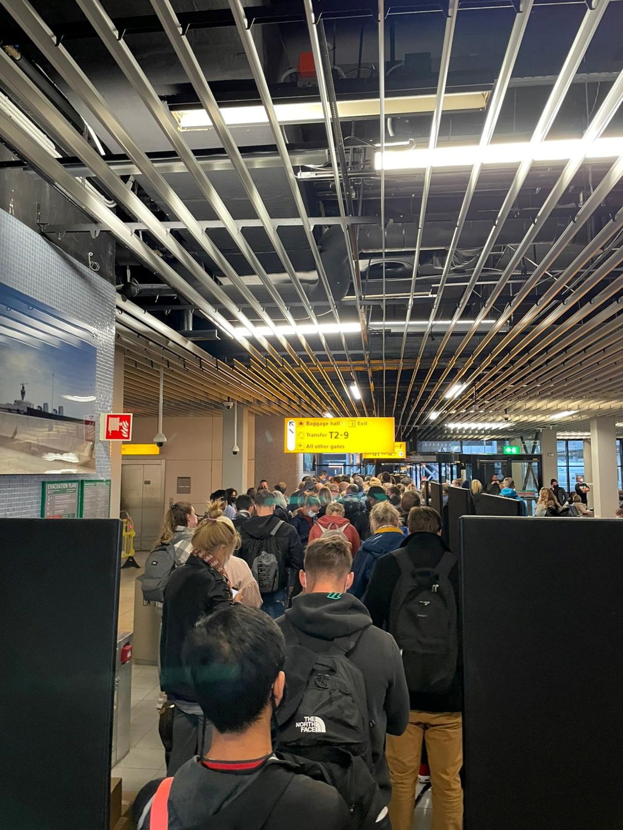 Passengers travelling from South Africa queue to be coronavirus disease (COVID-19) tested after being held on the tarmac at Schiphol Airport,?Netherlands?November 26th, 2021, in this picture obtained from social media