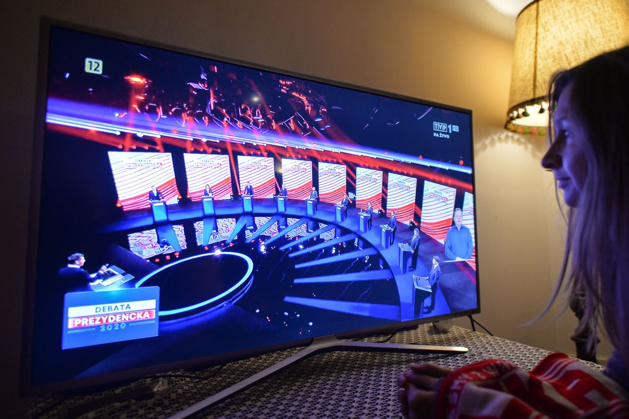 A woman watches the candidates take part in Poland's presidential debate in Krakow on May 6. 