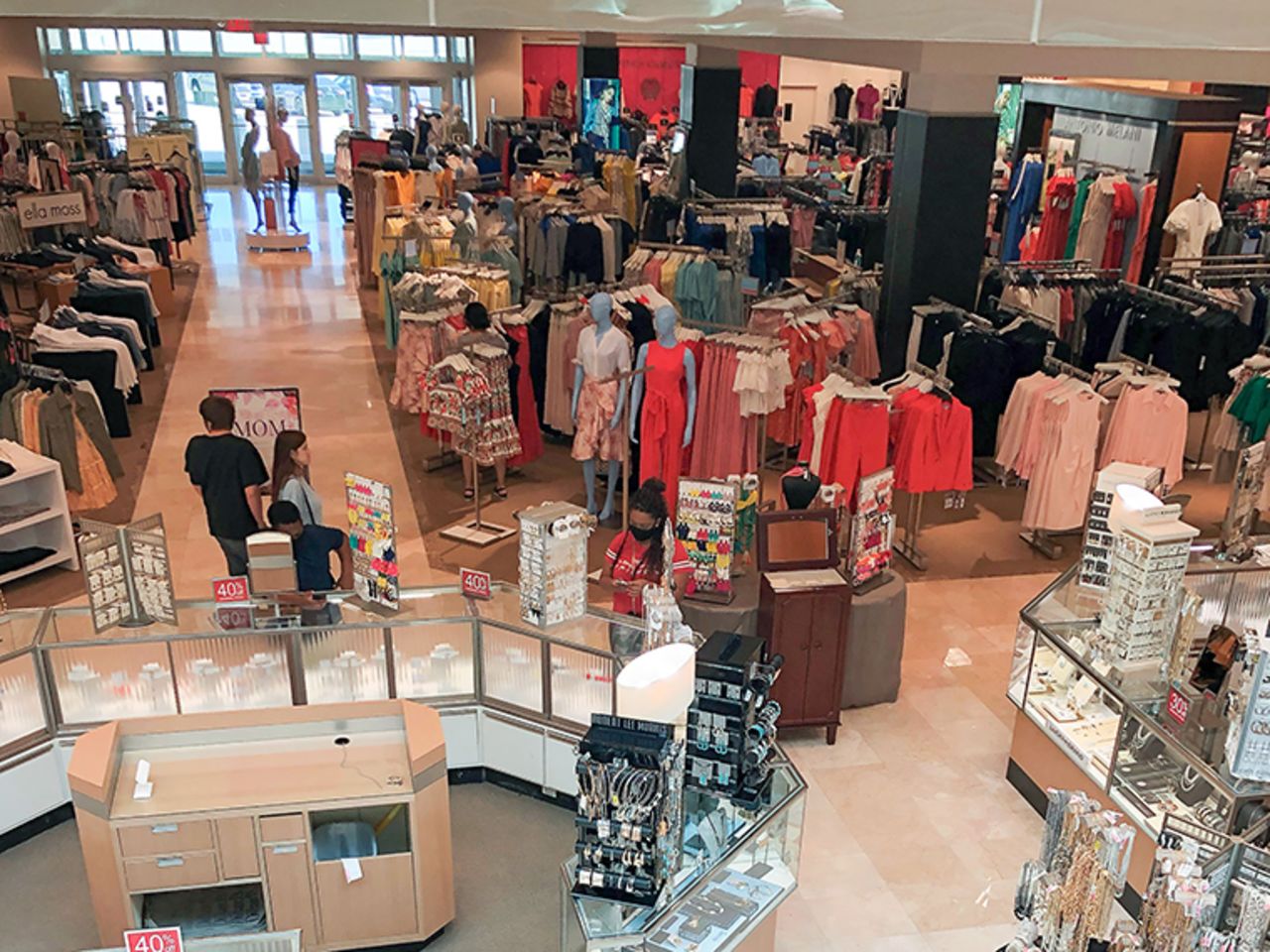  Customers shop at a shopping mall in Frisco, Texas, on Tuesday, May 5. The shopping mall reopened with shortened business hours on Tuesday. 