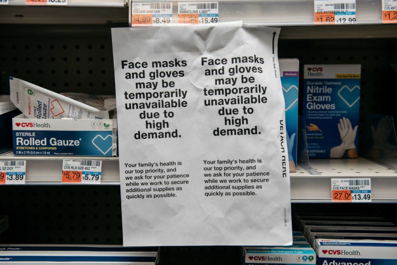 Amid fears of a growing coronavirus pandemic, signs for sold-out face masks are posted Wednesday in a New York pharmacy.?