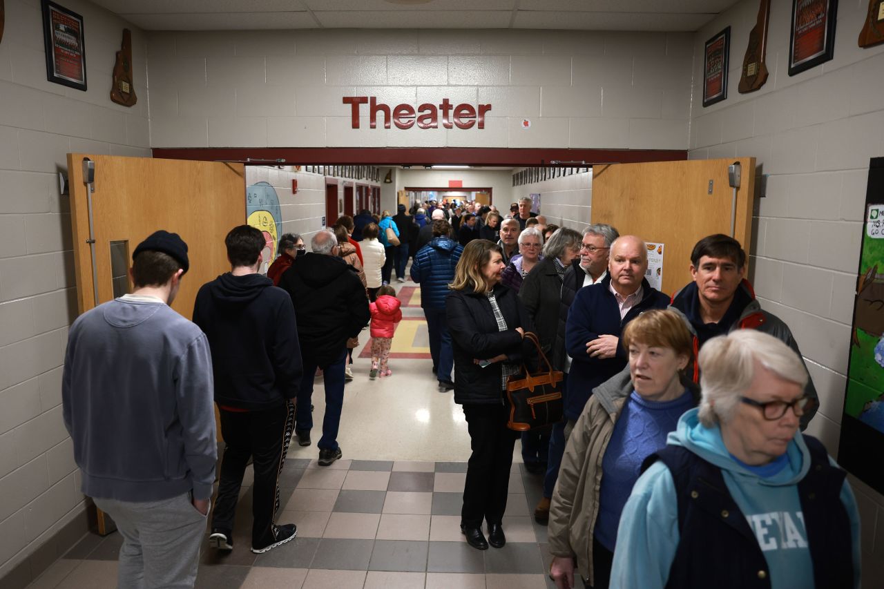 Voters wait in line to cast their ballots at Bedford High School in Bedford, New Hampshire.