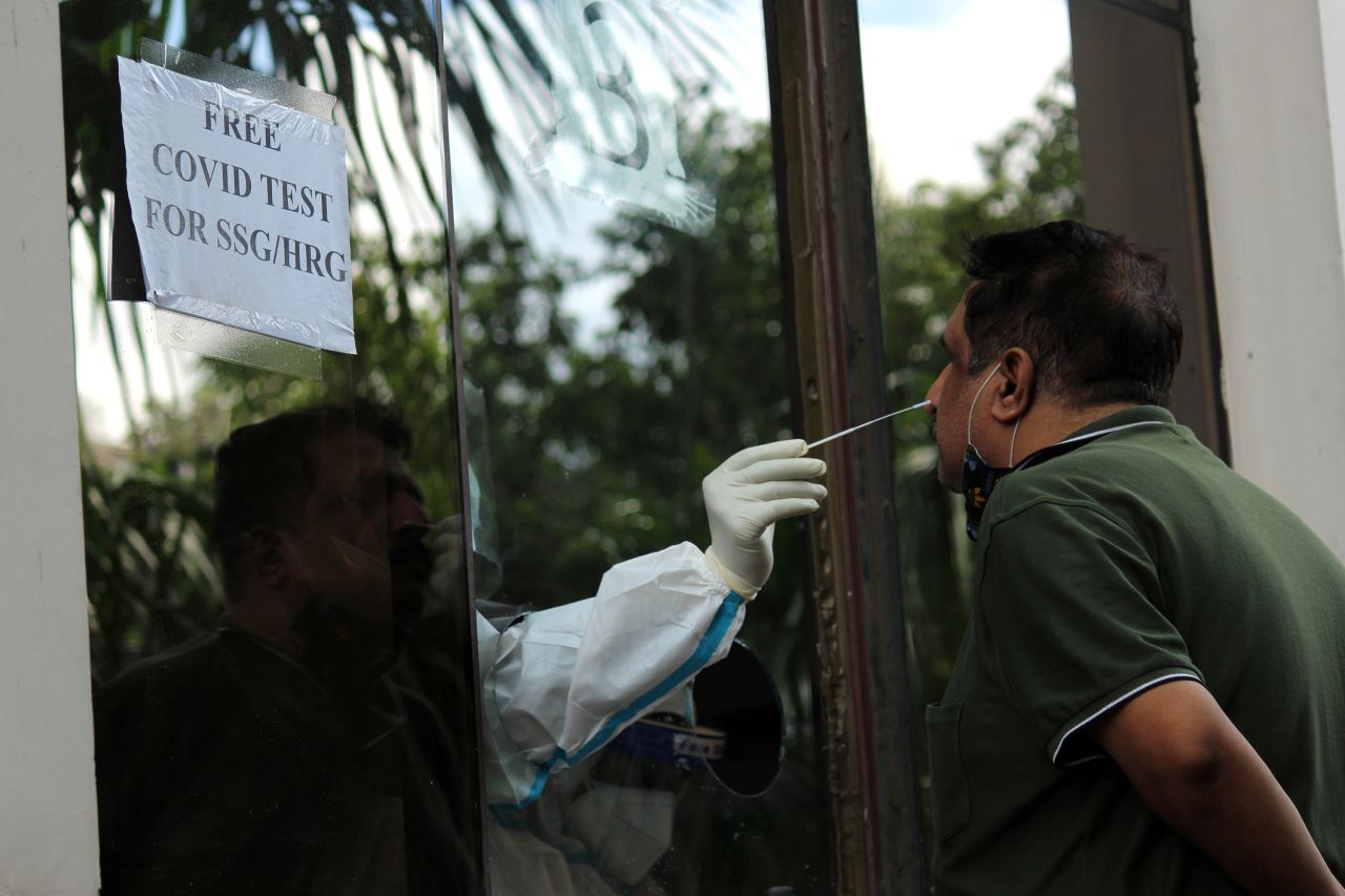 A health care worker collects a nasal swab sample from a patient to test with Rapid Antigen Test (RAT) for the COVID-19 infection in New Delhi, India, on August 22. 