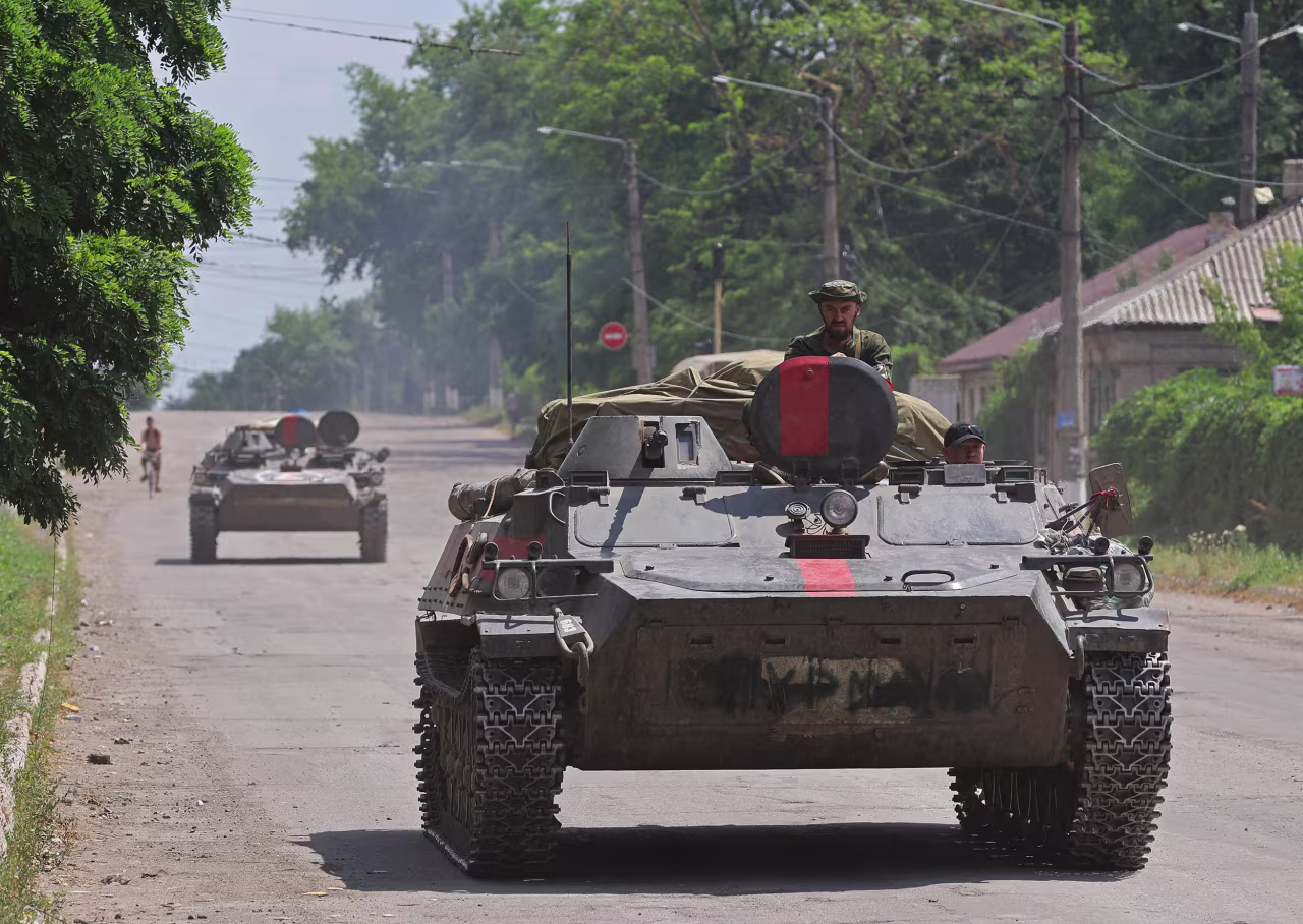 Pro-Russian troops ride an infantry fighting vehicle in the city of Lysychansk in the Luhansk Region, Ukraine, on July 4.
