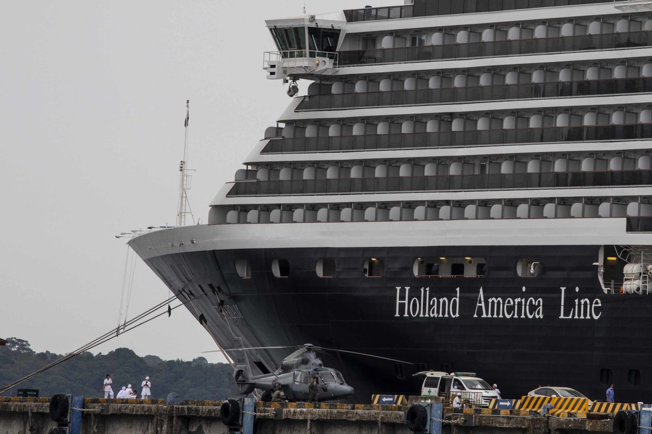 Health officials stand guard outside the MS Westerdam cruise ship in Sihanoukville, Cambodia on Monday.