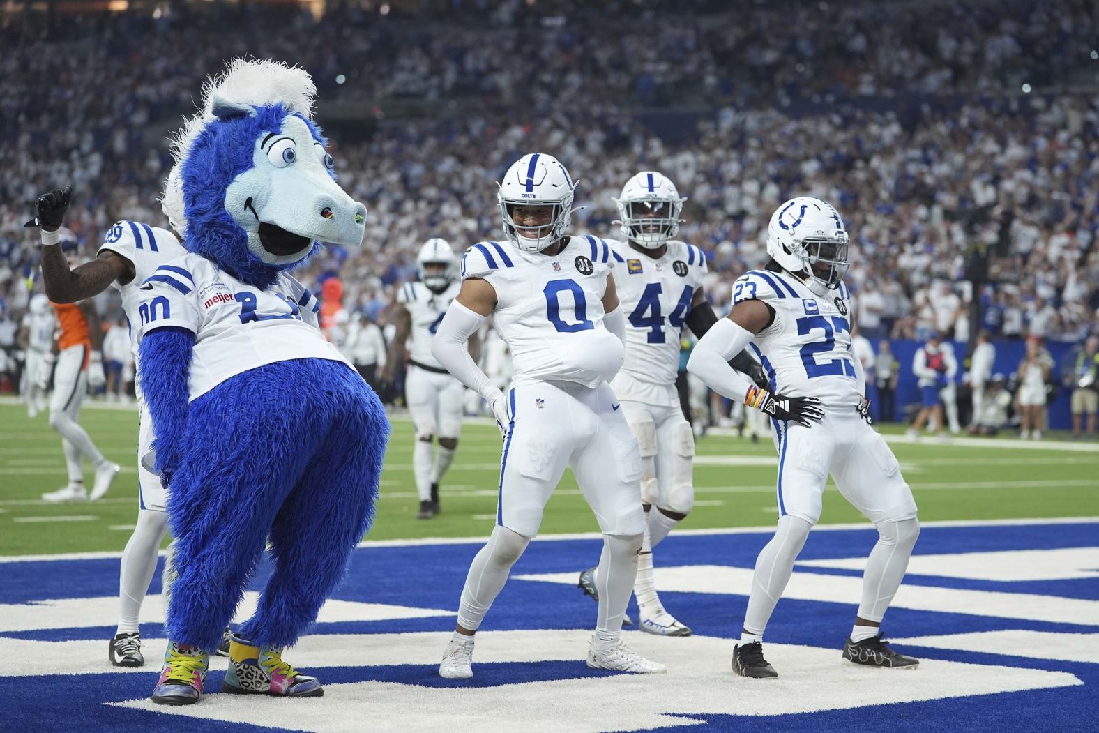 Blue, the Indianapolis Colts’ mascot, joins several Colts players to celebrate an interception by safety Cam Bynum (No. 0) during an NFL game on Sunday, September 14.