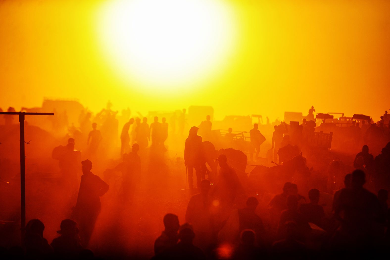 Palestinians receive supplies after aid trucks enter through the Netzarim Corridor in Gaza on Thursday, June 26.