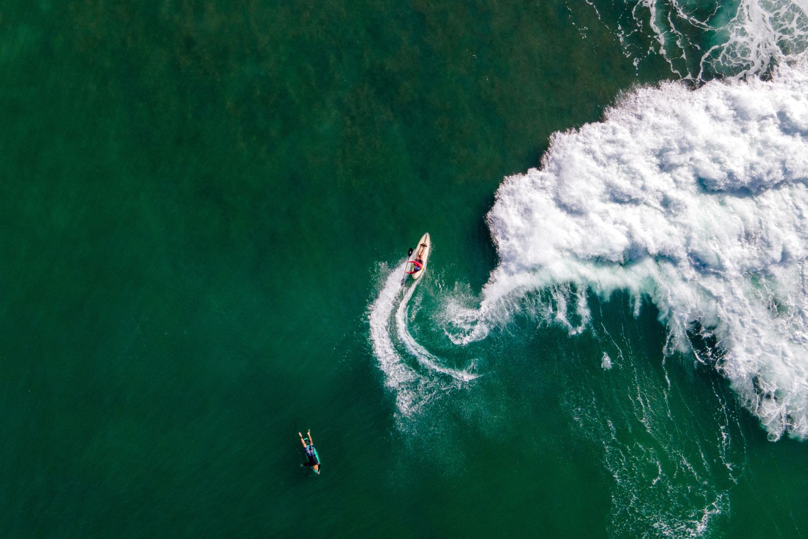 A paddle-skier rides a wave at the Lhoknga Beach near Banda Aceh, Indonesia, on Tuesday, January 21.