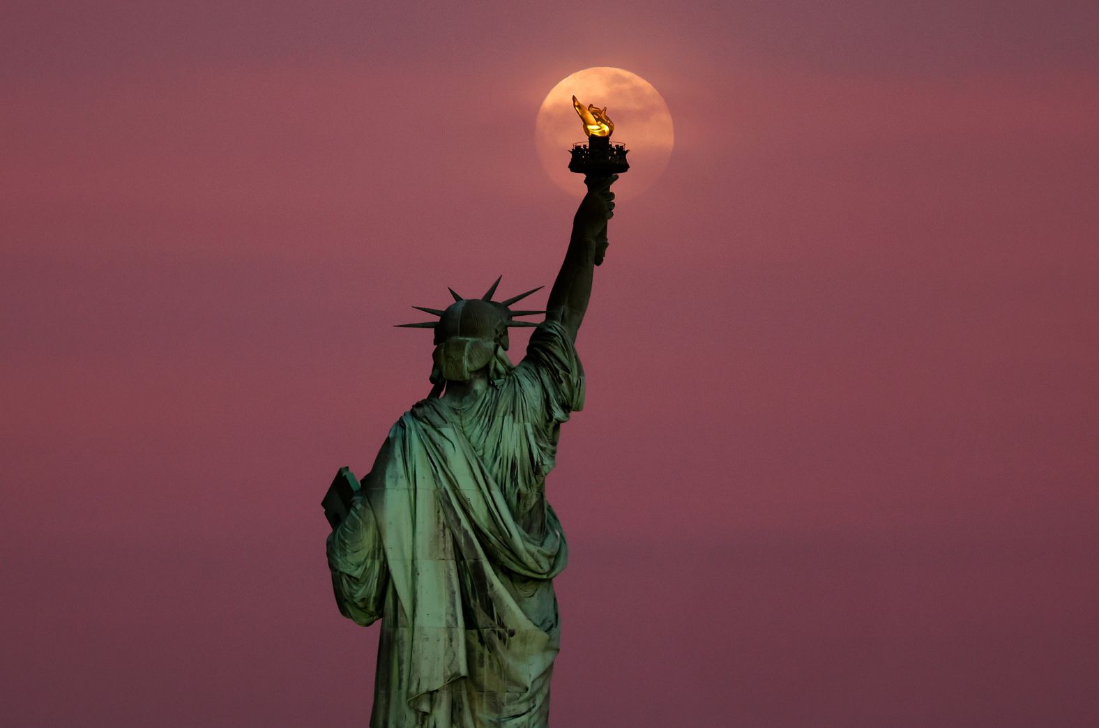 A full moon is seen behind the Statue of Liberty in New York on Sunday, May 11. <a href="index.php?page=&url=https%3A%2F%2Fwww.cnn.com%2F2025%2F05%2F08%2Fworld%2Fgallery%2Fphotos-this-week-may-1-may-8">See last week in 39 photos</a>.