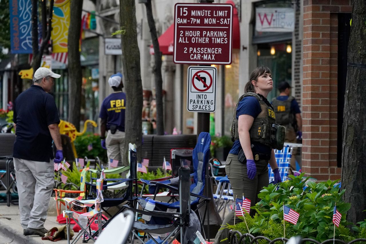 Members of the FBI conduct a search after the shooting in Highland Park, Illinois, on Monday.