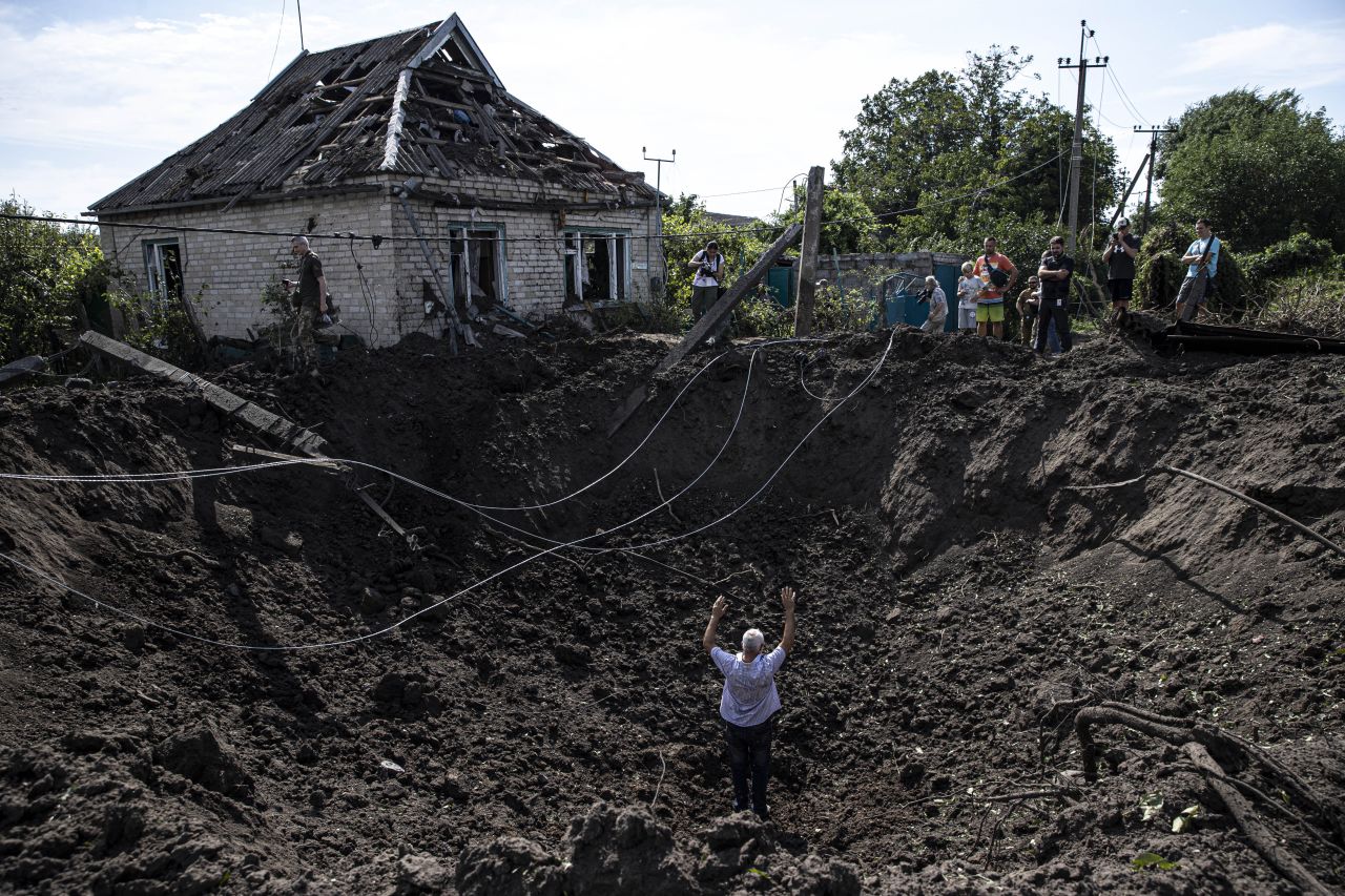 People inspect damage after Russian shelling in a village of Zaporizhzhia Oblast, Ukraine on Aug. 10. 