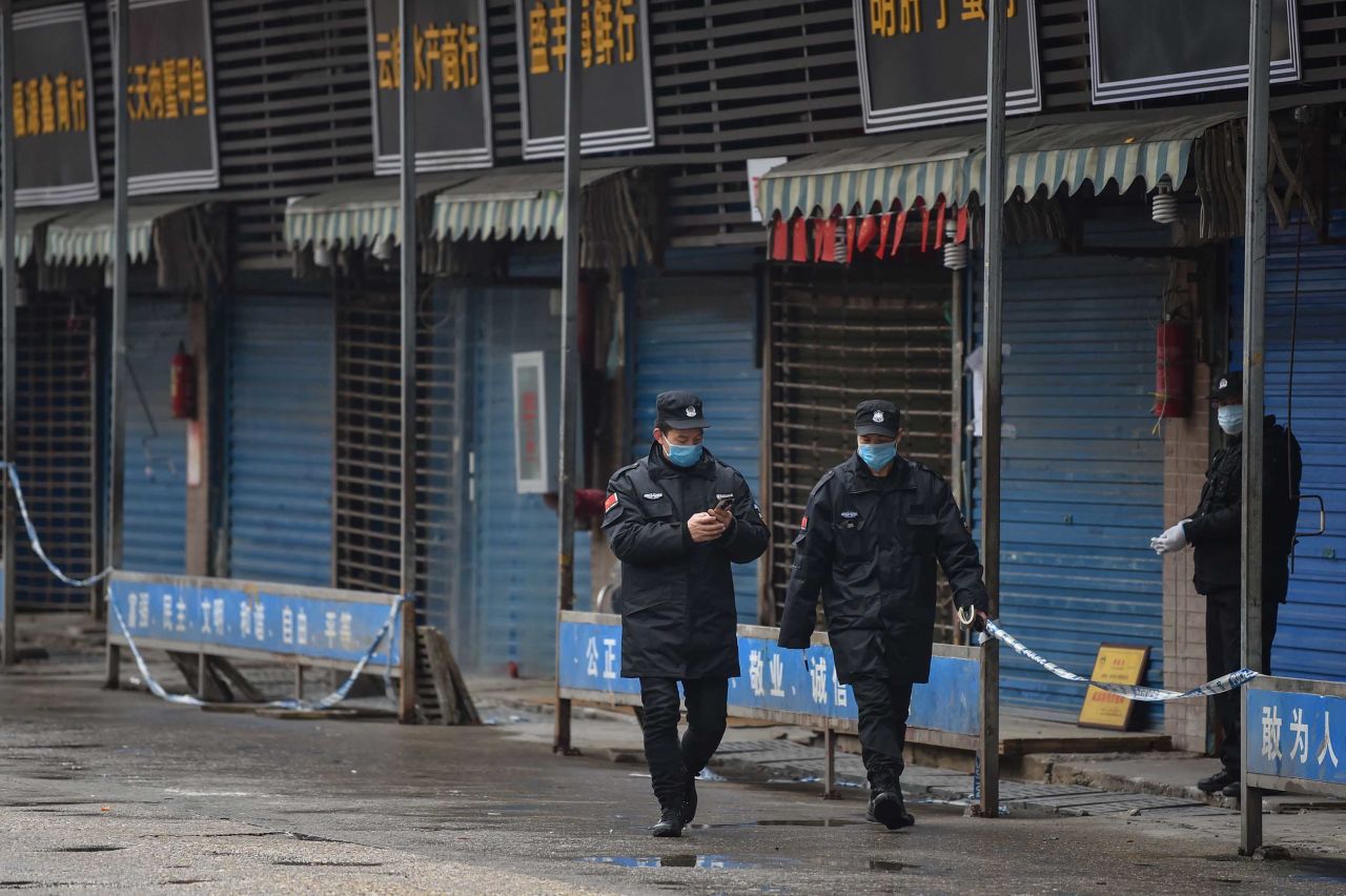 Guards patrol on January 24 outside the Huanan Seafood Wholesale Market in Wuhan, believed to be the source of the virus. 