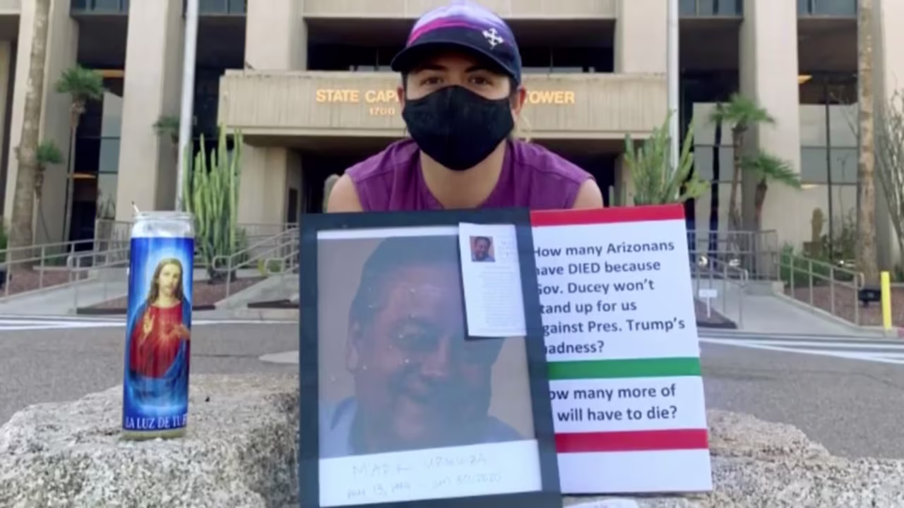 Kristin Urquiza poses with a photo of her father who died of Covid-19.