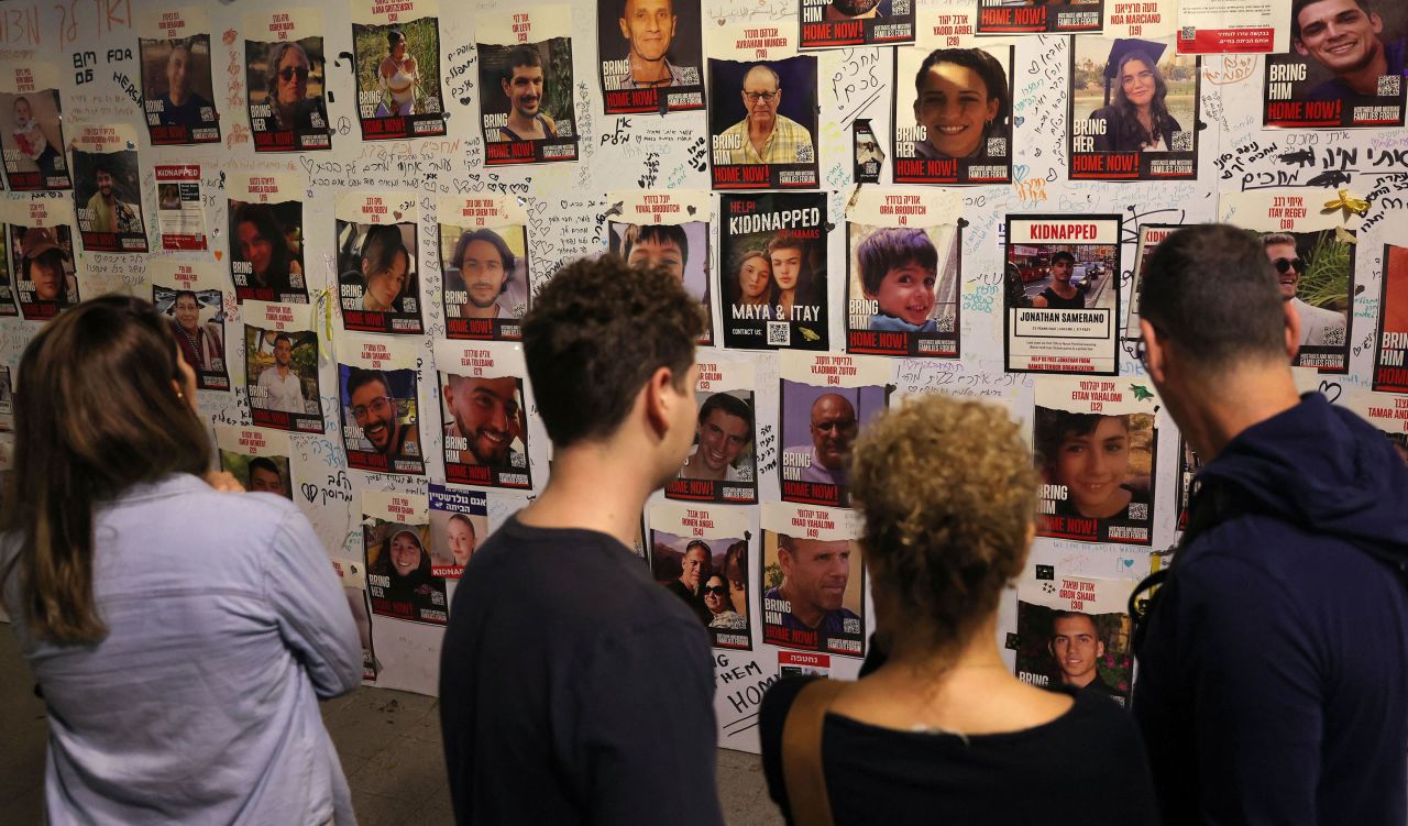 People look at pictures of Hamas' hostages during a demonstration in Tel Aviv, Israel, calling for their release on November 11. 