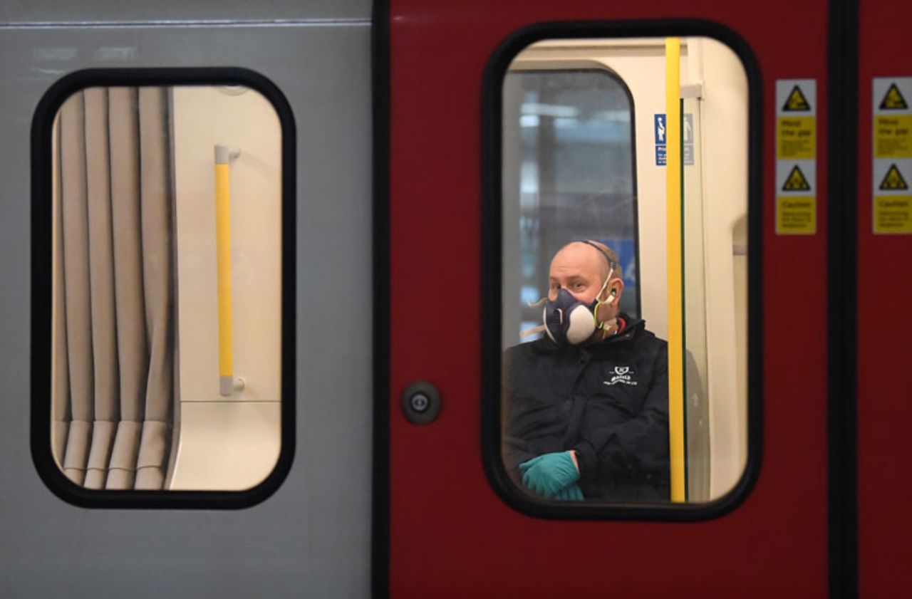 A member of the public wears a a protective mask on the Tube on March 25  in London, England.