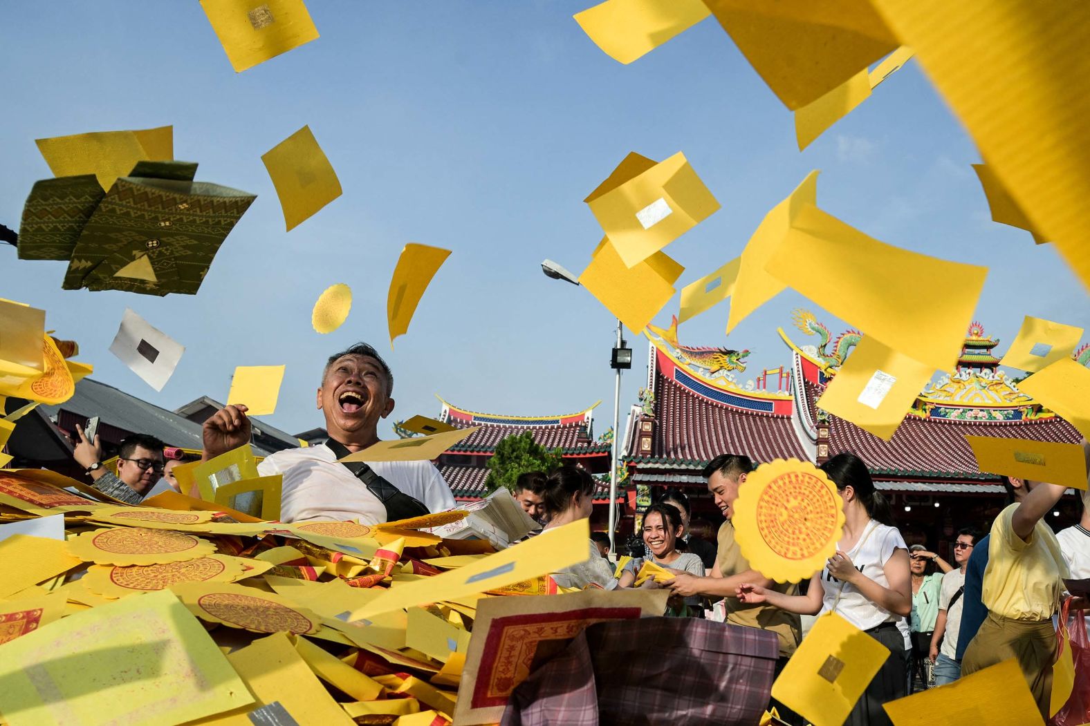 Buddhists throw fake money at the Gunung Timur Temple to honor their ancestors during the Hungry Ghost Festival in Medan, Indonesia, on Saturday, September 6. The festival is observed in Chinese communities, with offerings of food, incense and paper money to wandering spirits.