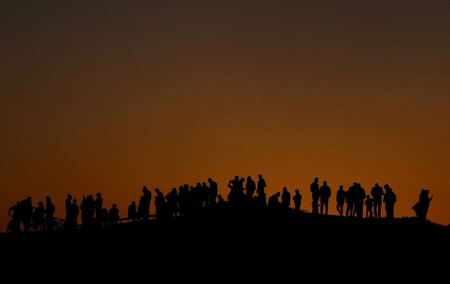 Displaced Palestinians in Rafah, Gaza, try to get internet service on their phones on March 4.