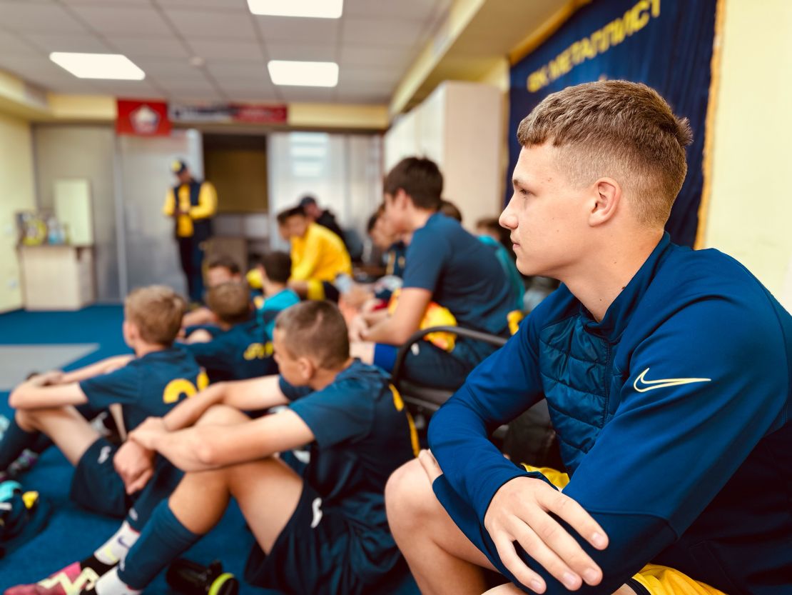 Matviy Kolotay, an academy player at FC Metalist Kharkiv, watches the first team play a match after Saturday training.