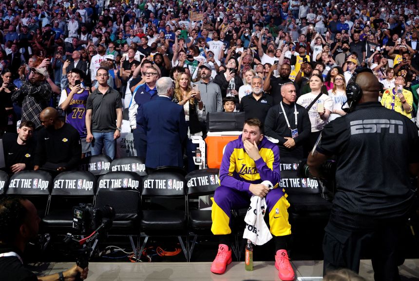 Luke Dončić reacts while watching a tribute video in his first game back in Dallas in April.