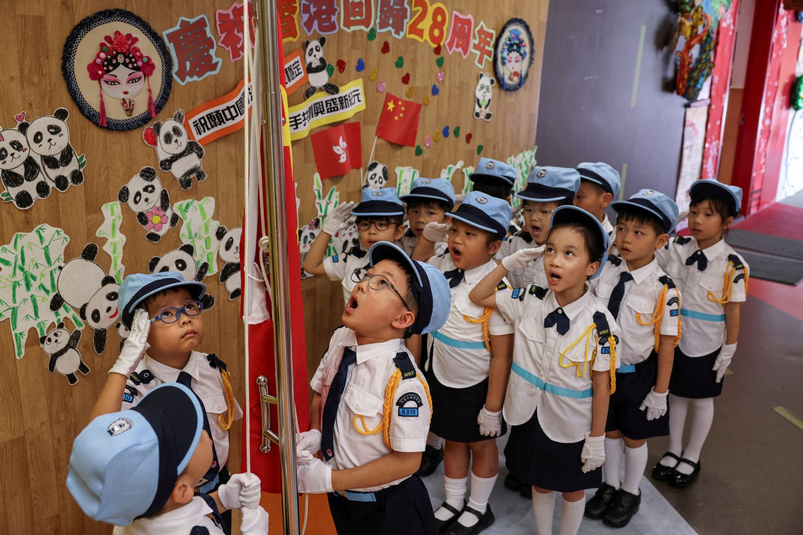 Kindergarteners participate in a flag-raising ceremony at a school in Hong Kong on Monday, June 30.