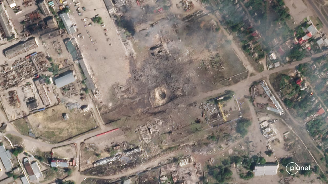 A massive crater is seen after a Ukrainian missile hit a building — which Ukrainian officials say was being used as an ammunition depot by Russia — in Russian-occupied Nova Kakhovka in the Kherson region of Ukraine. The satellite image was taken on July 12, according to Planet Labs. 