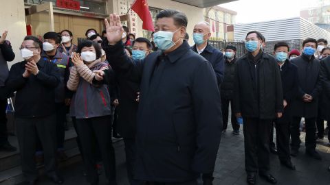 Chinese President Xi Jinping, center, wears a protective face mask during an appearance in Beijing on Monday.