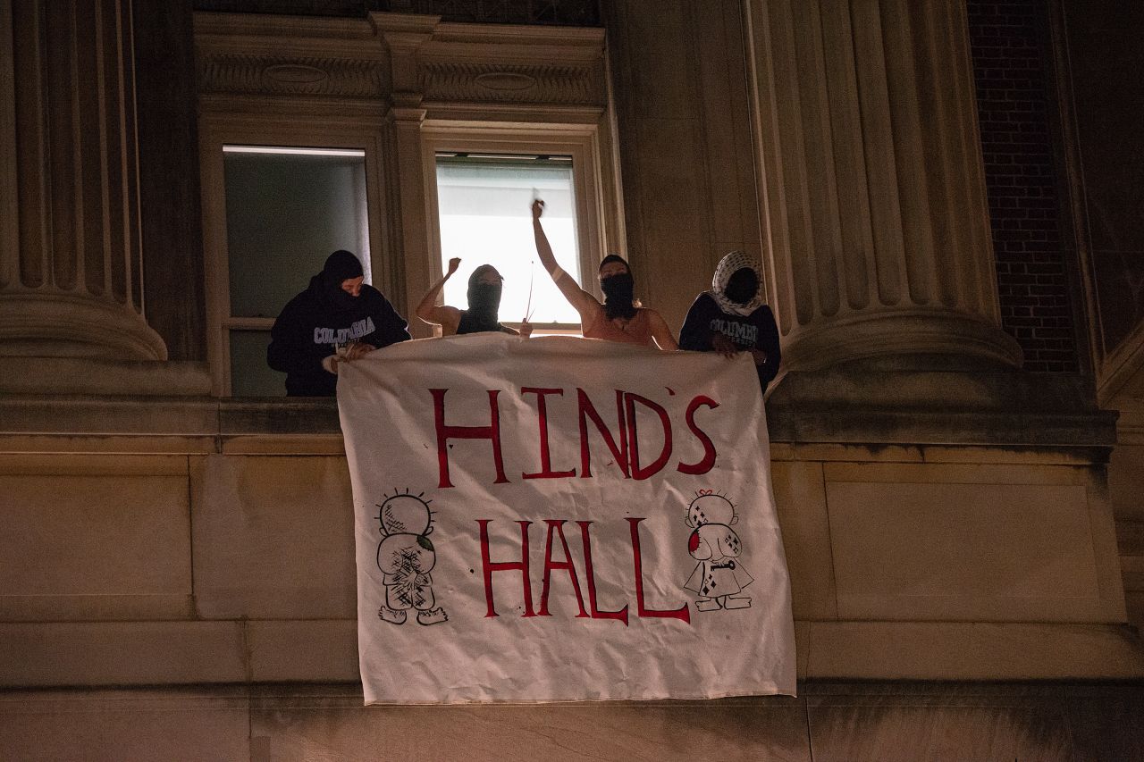 People hang a banner outside of Hamilton Hall at Columbia University in New York in the early hours of Tuesday.