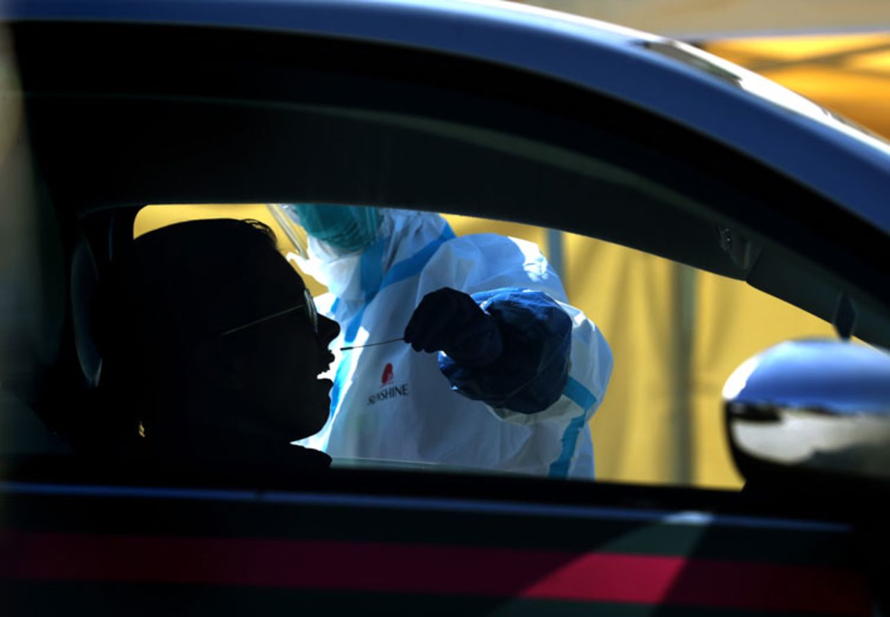 A medical professional?administers a coronavirus test during a drive-thru testing station on March 26 in Daly City, California. 