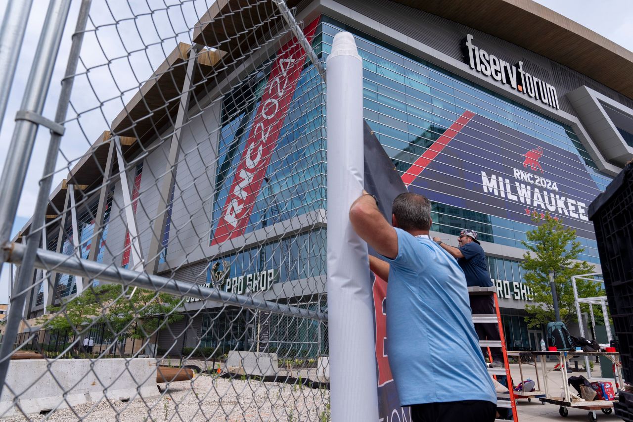 Signage is attached to security fencing ahead of the 2024 Republican National Convention at the Fiserv Forum in Milwaukee on July 10. 