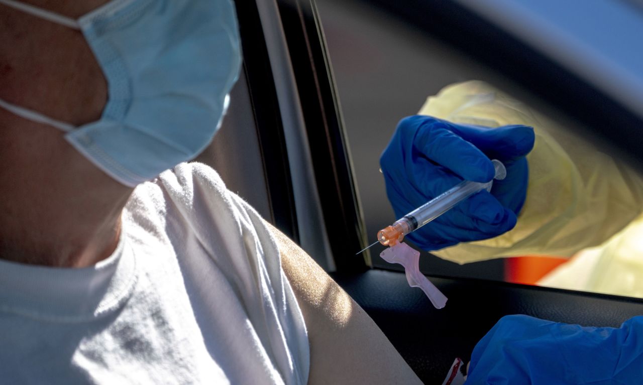 A health care worker administers a dose of the Moderna Covid-19 vaccine at a drive-thru vaccination site in Fontana, California, on February 2.